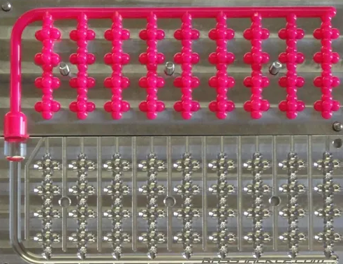 Salmon egg cluster mold shown with pink soft plastic eggs